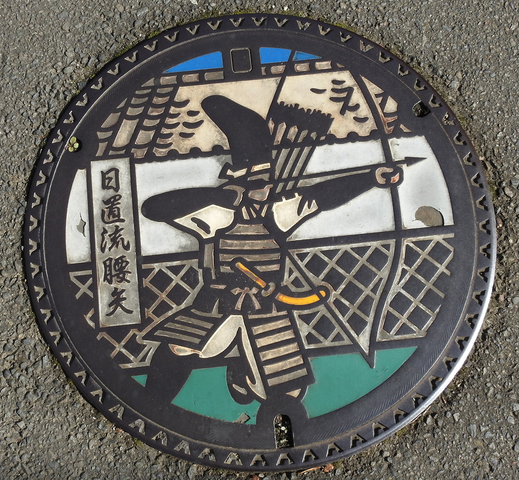 Japanese drain covers are an art form! Here a samurai archer kneels to shoot in Izumi Bukeyashiki © Mark Brazil